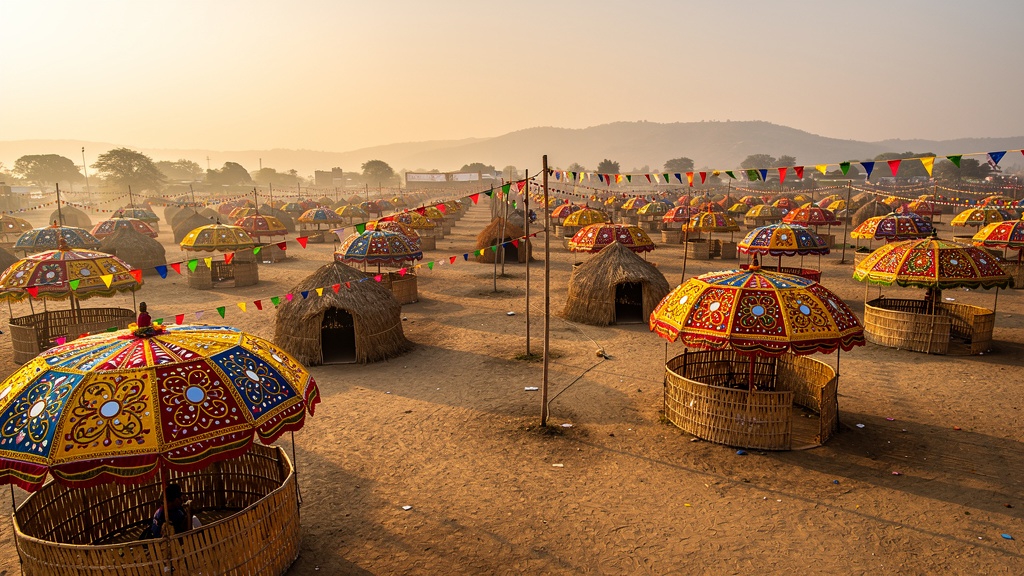 The vast Tarnetar fairground dotted with hundreds of colourful embroidered umbrellas and stall circles